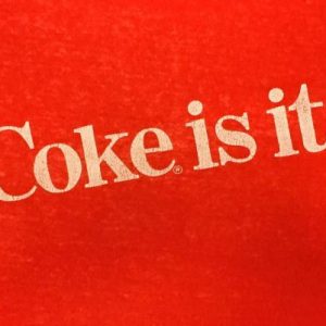 Vintage 1980s Coke Is It Coca Cola Red Slogan T-Shirt S/M